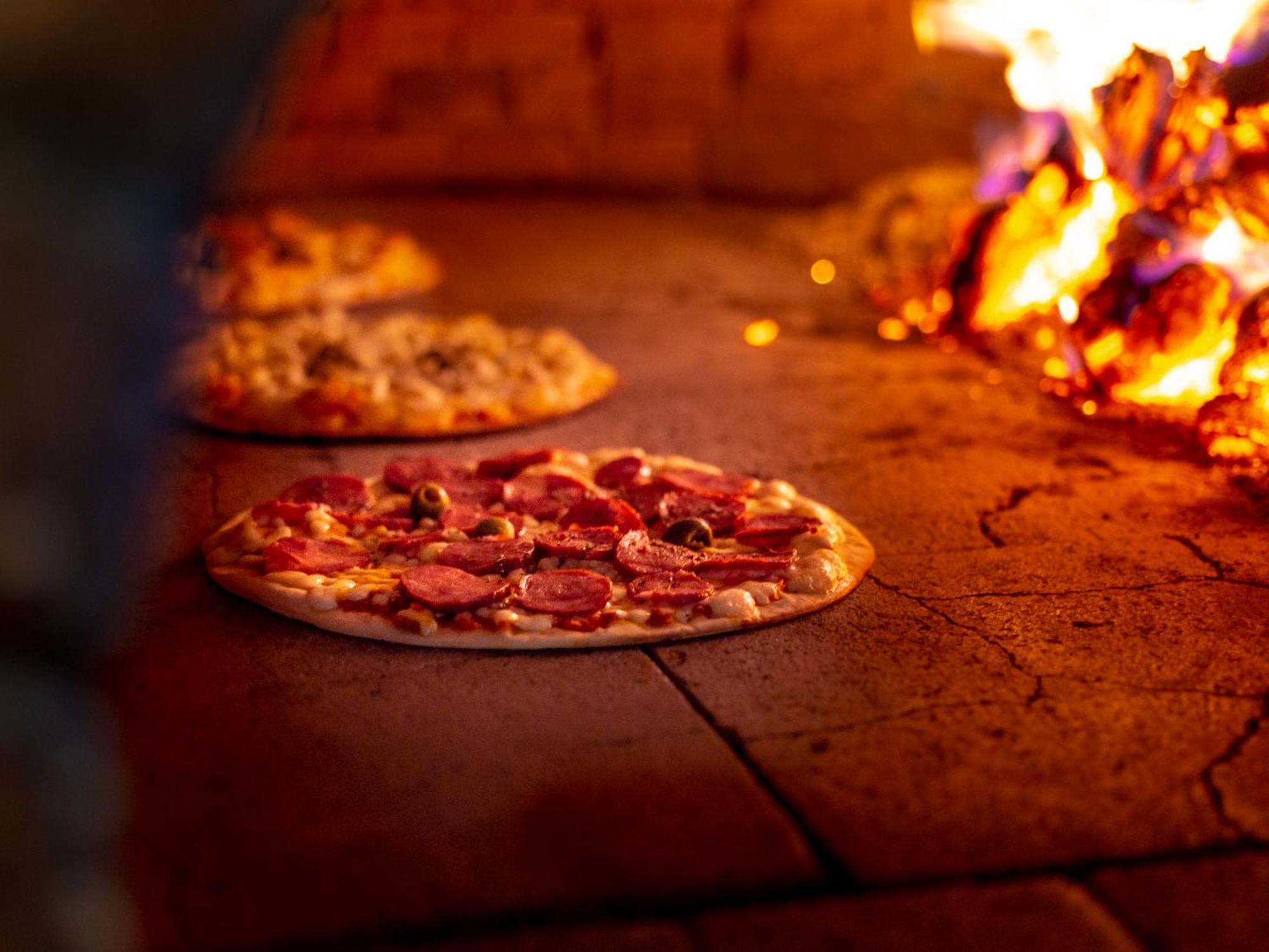 Ocean Palace All Inclusive Premium Natal Exteriér fotografie Pizza being cooked in a wood-fired oven
